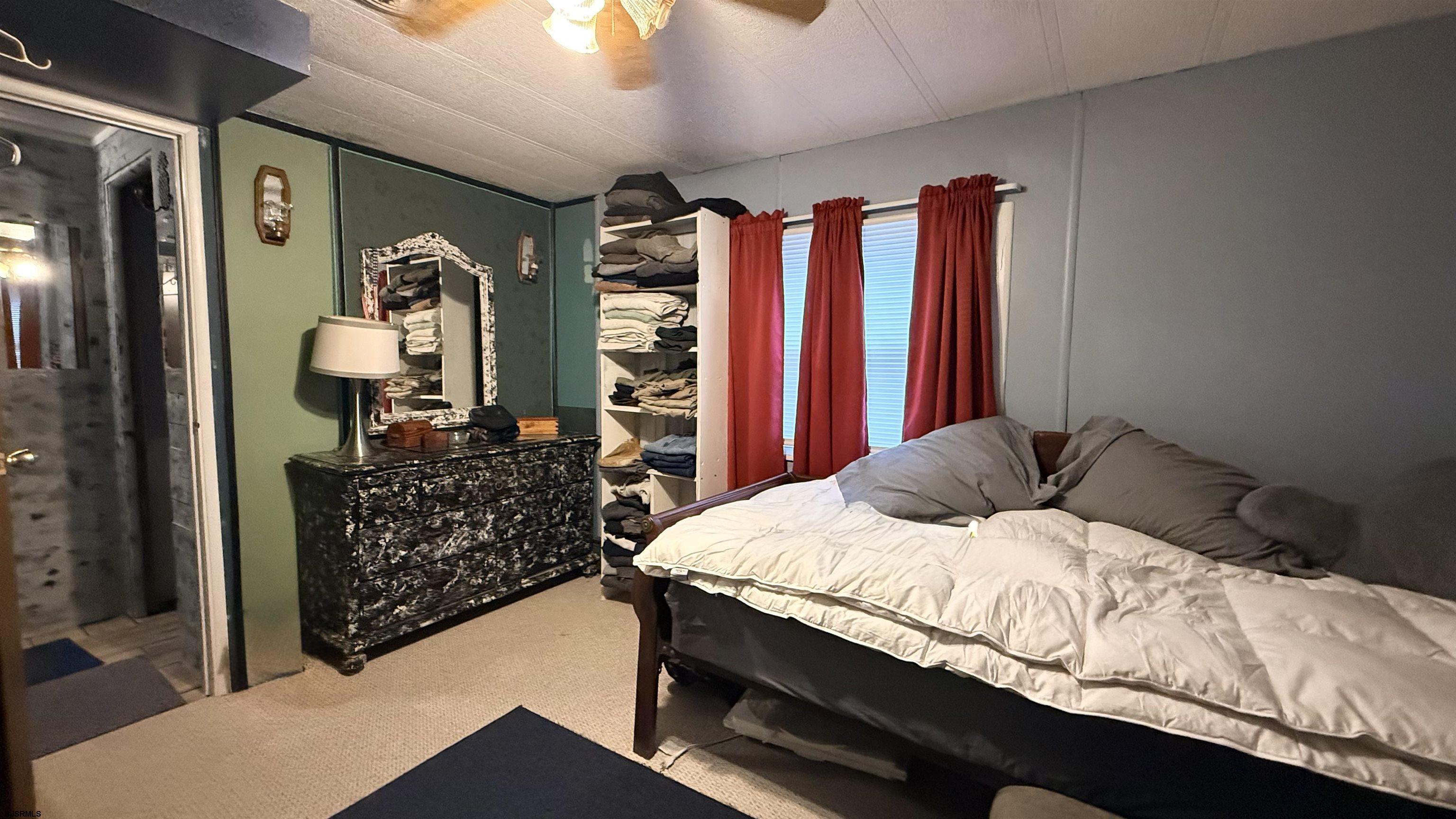 101 Country Lane Buena, NJ 08310 - Photo 19 of 25 a bedroom with a bed and dresser with mirror