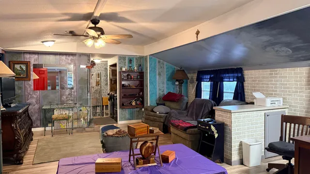 a view of a livingroom with workspace and a window