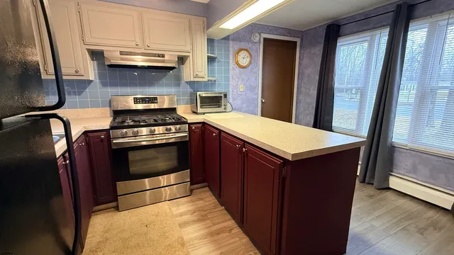 a kitchen with a stove and a refrigerator