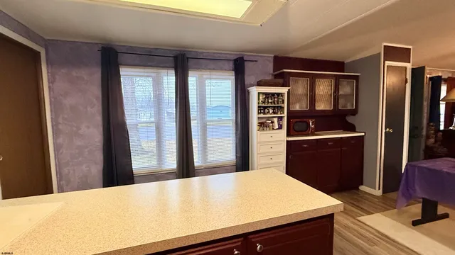 a kitchen with kitchen island a counter appliances a sink and refrigerator