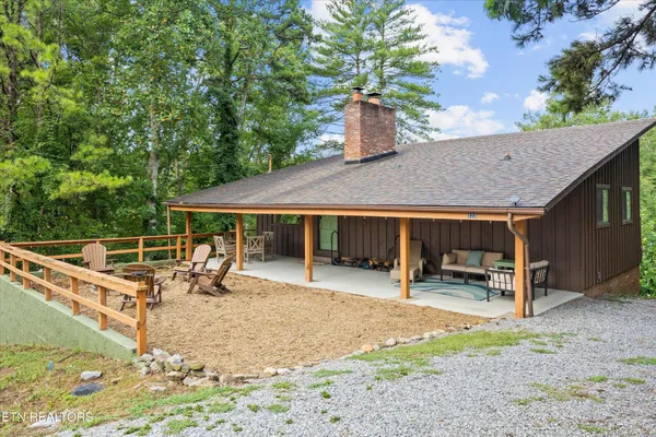 a view of a house with backyard porch and sitting area