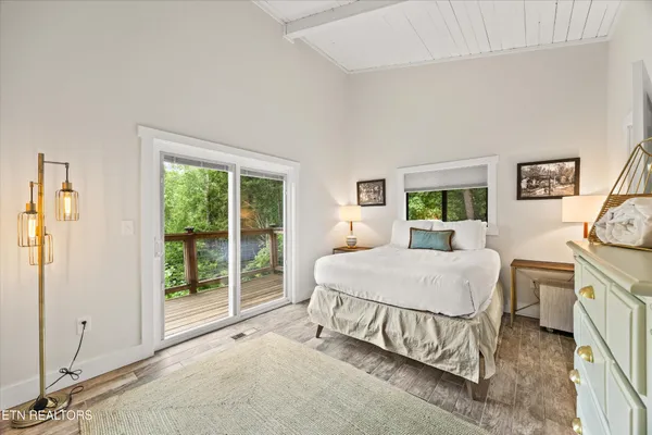 a bedroom with a bed and a lamp