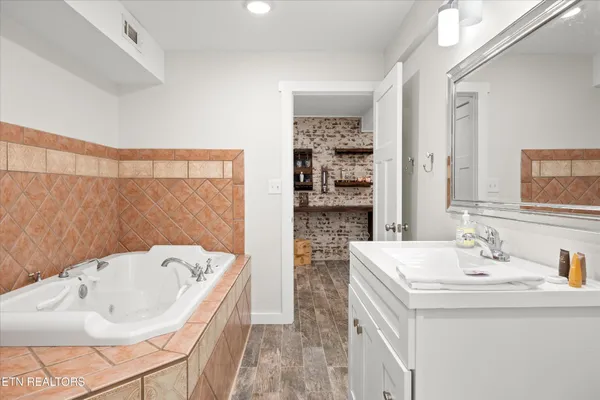 a bathroom with a sink toilet and a mirror