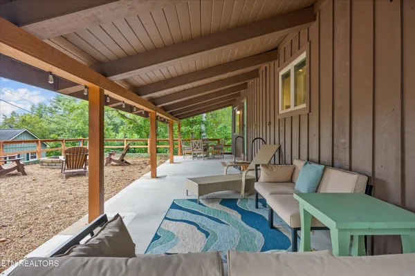 a view of a patio with table and chairs and wooden floor