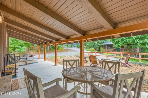 a view of a patio with a table chairs and a potted plant