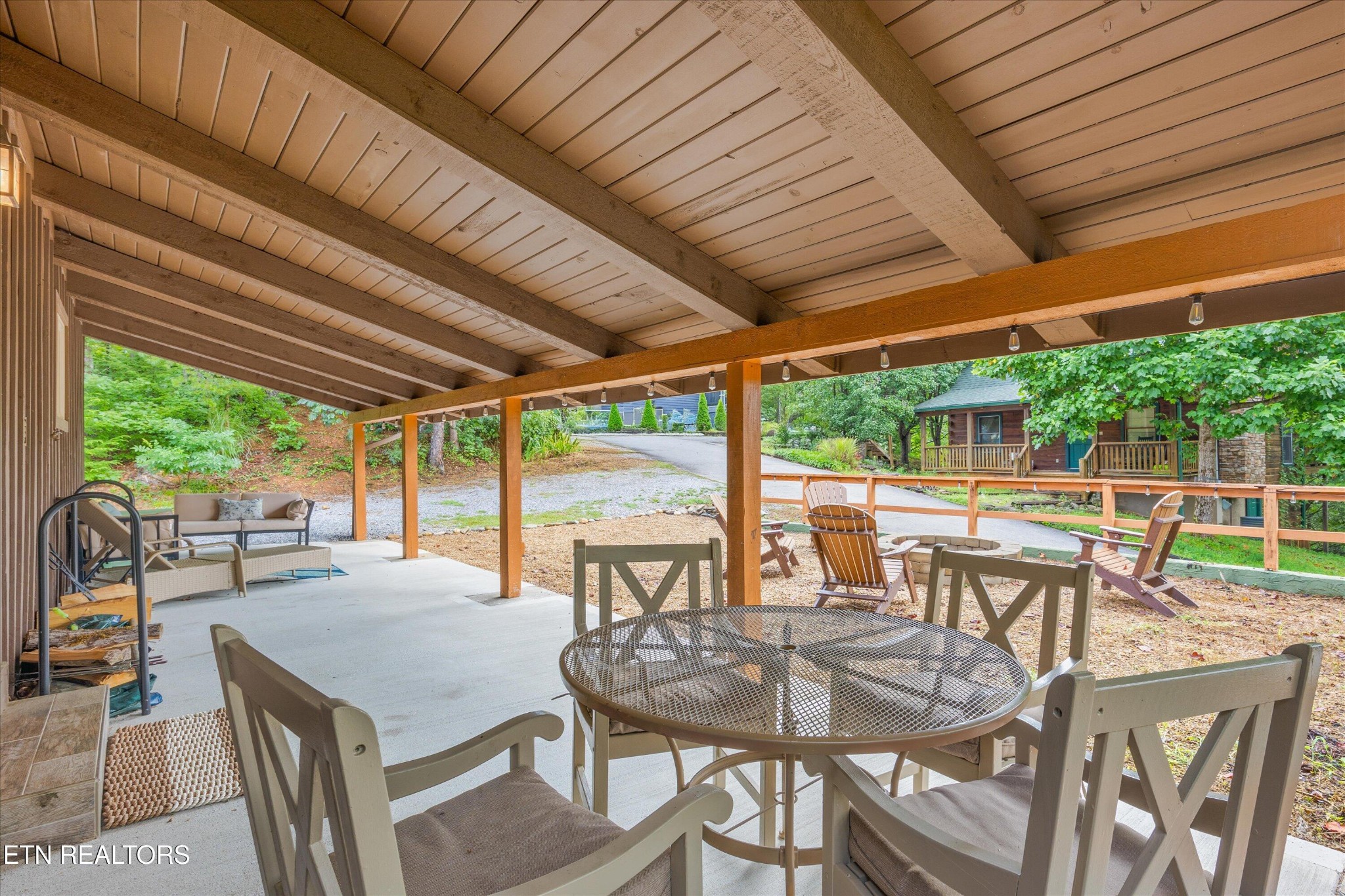 123 Cutter Gap Road Townsend, TN 37882 - Photo 26 of 40 a view of a patio with table and chairs and wooden floor
