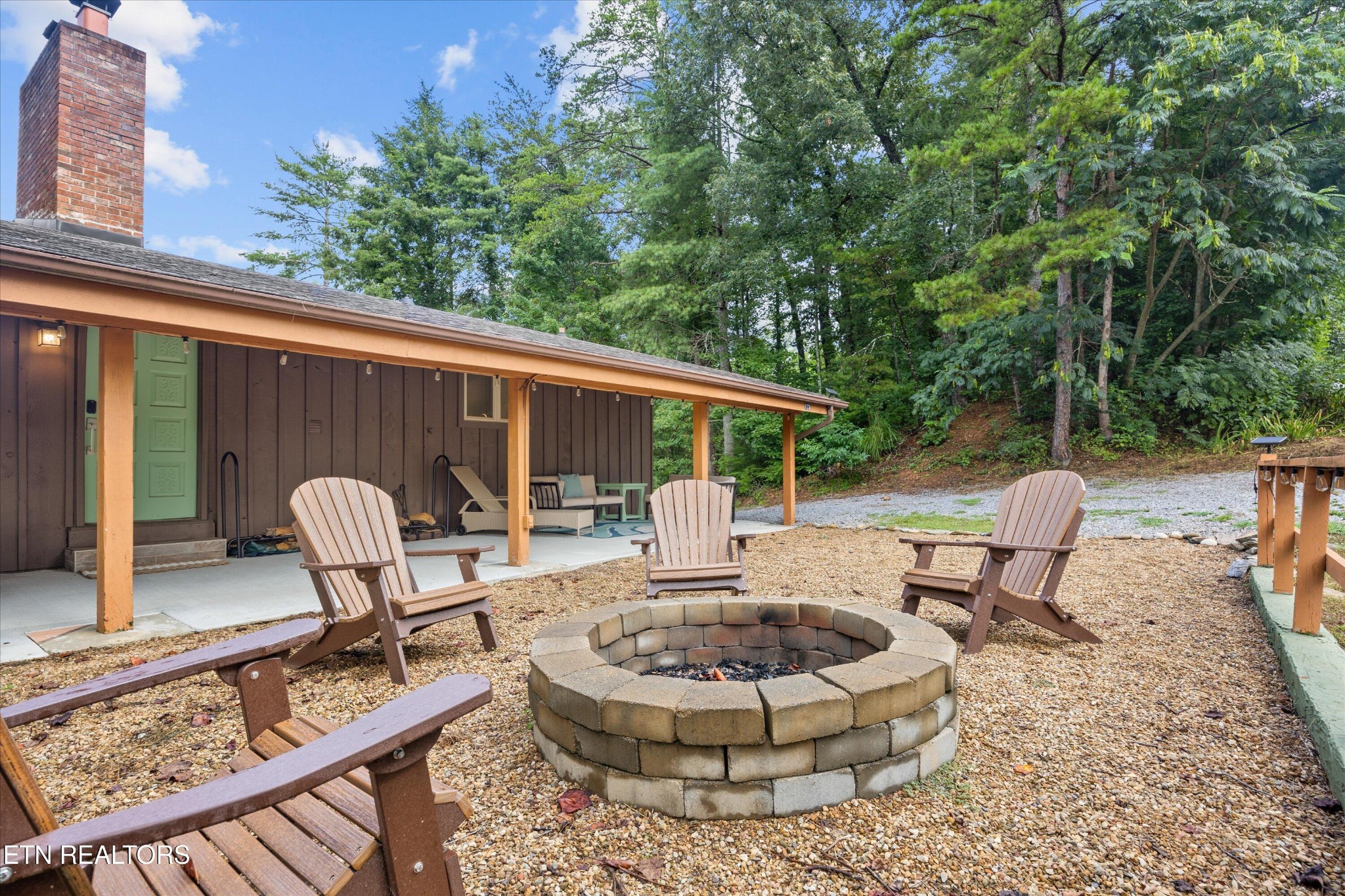123 Cutter Gap Road Townsend, TN 37882 - Photo 27 of 40 a view of a patio with a table chairs and a potted plant
