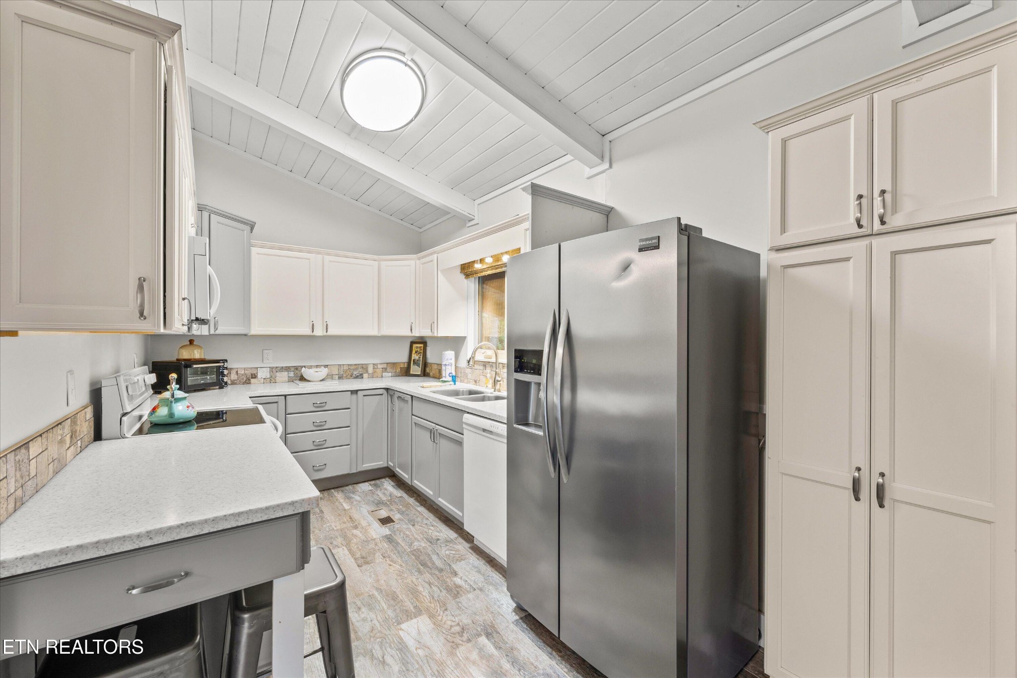 123 Cutter Gap Road Townsend, TN 37882 - Photo 10 of 40 a kitchen with a refrigerator a sink and dishwasher a oven with white cabinets