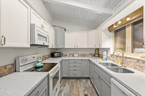 a kitchen that has a sink and a stove in it