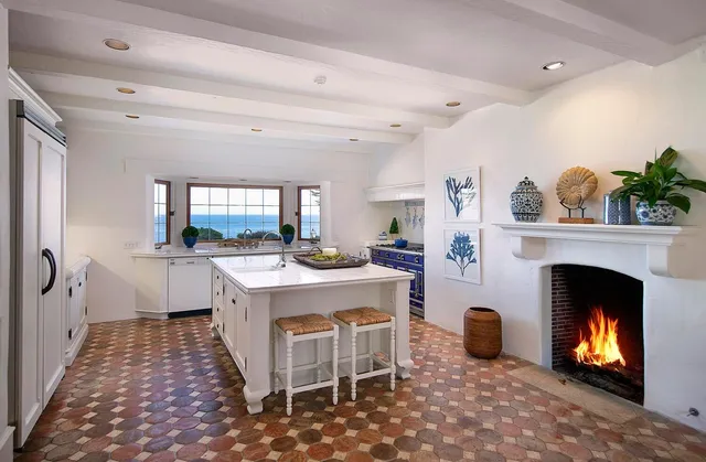 a living room with furniture a fireplace and a table