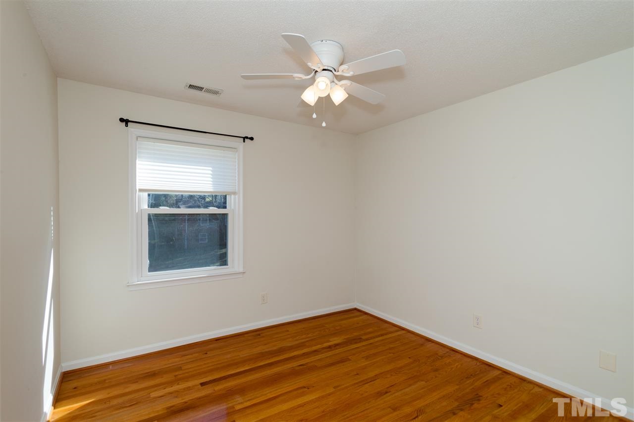 2400 Lawrence Drive Raleigh, NC 27603 - Photo 11 of 24 Bedroom one with hardwood floors and ceiling fan.
