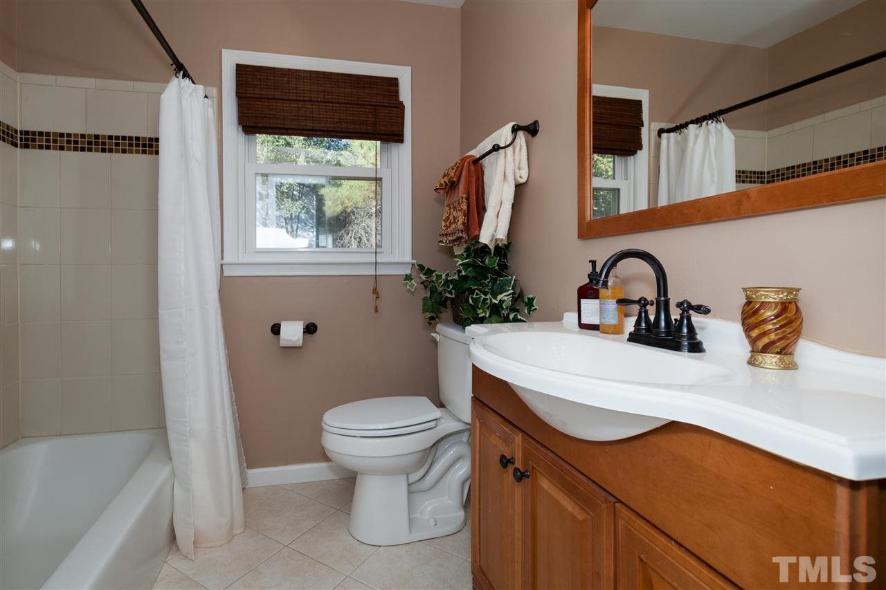 2400 Lawrence Drive Raleigh, NC 27603 - Photo 15 of 24 Updated bathroom with new vanity and sink, tile floors, and tile shower/tub.