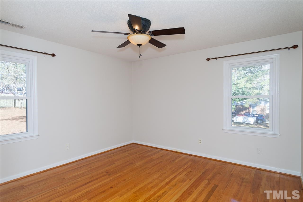 2400 Lawrence Drive Raleigh, NC 27603 - Photo 9 of 24 Master bedroom with hardwood floors and ceiling fan