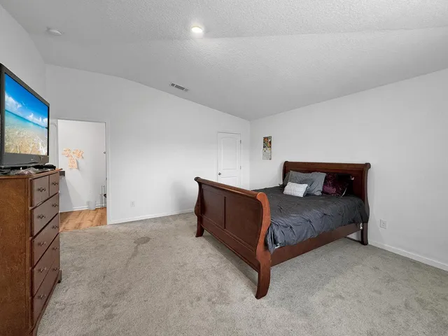 a bed room with a bed and a television