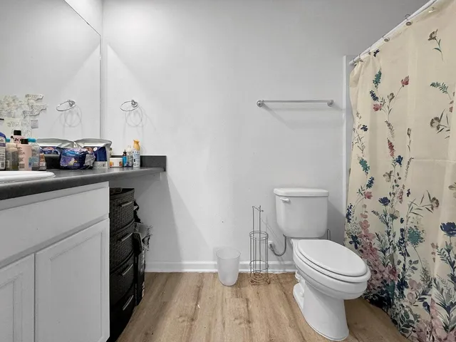 a bathroom with a sink a toilet and a mirror