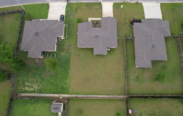 an aerial view of residential houses with outdoor space and swimming pool