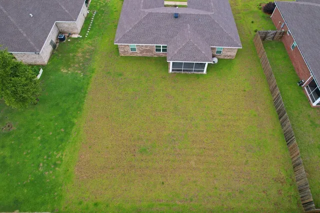 an aerial view of house with yard swimming pool and outdoor seating