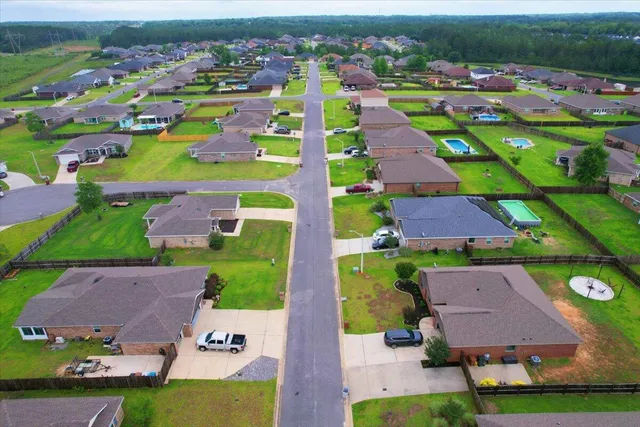 an aerial view of residential houses with outdoor space