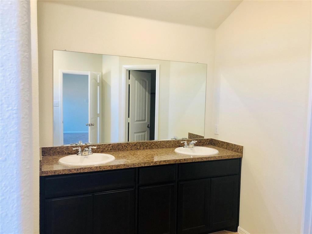 925 Rutherford Drive Crowley, TX 76036 - Photo 8 of 17 a bathroom with a granite countertop sink and a mirror