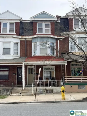 a front view of a building and car parked