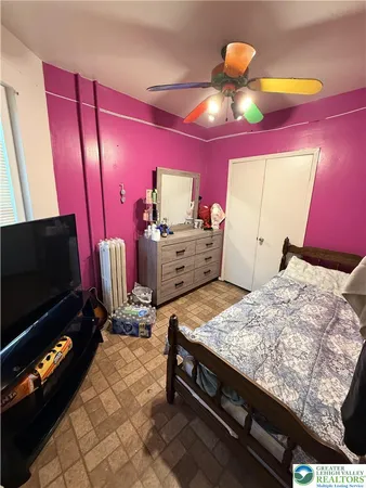 a bed room with a bed and a television