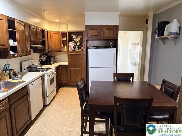 a kitchen with stainless steel appliances a stove refrigerator sink and microwave