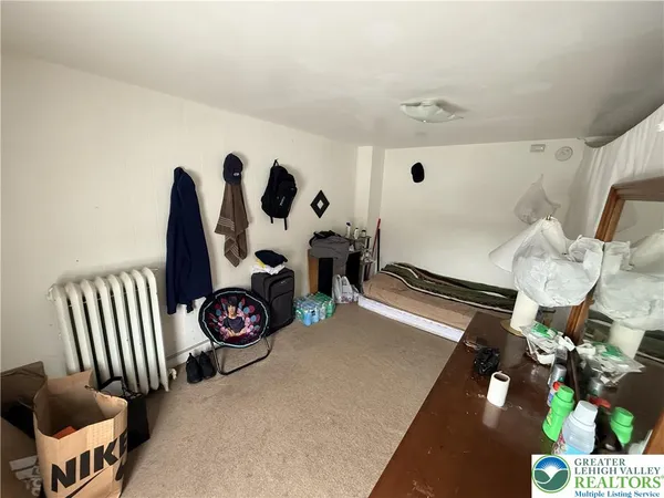 a view of living room with furniture and white walls
