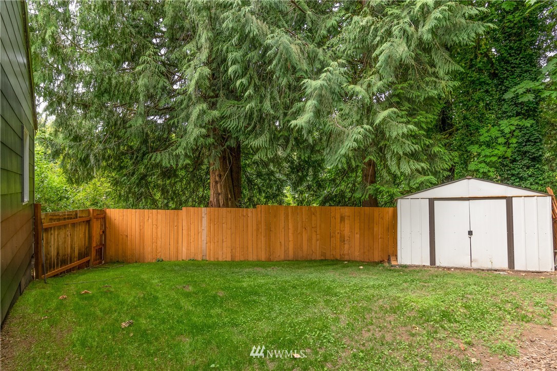 732 Coal Creek Road Longview, WA 98632 - Photo 26 of 35 a view of backyard with large trees and wooden fence