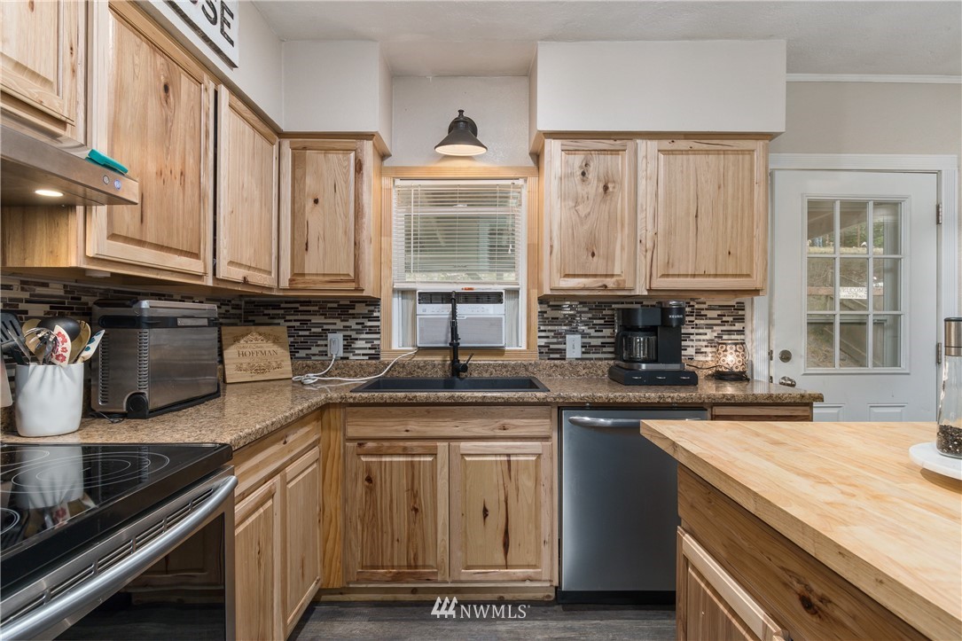 732 Coal Creek Road Longview, WA 98632 - Photo 7 of 35 a kitchen with stainless steel appliances granite countertop a sink stove and cabinets