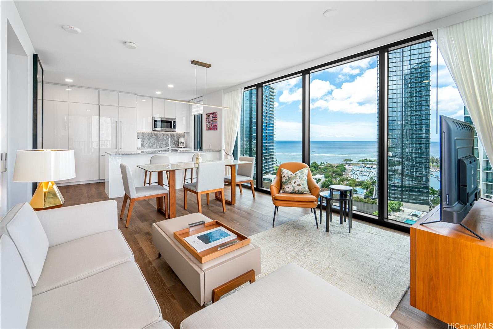 987 Queen Street, Unit 2001 Honolulu, HI 96814 - Photo 1 of 1 a living room with furniture and a large window