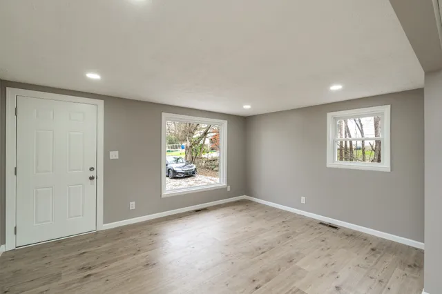 an empty room with windows and closet