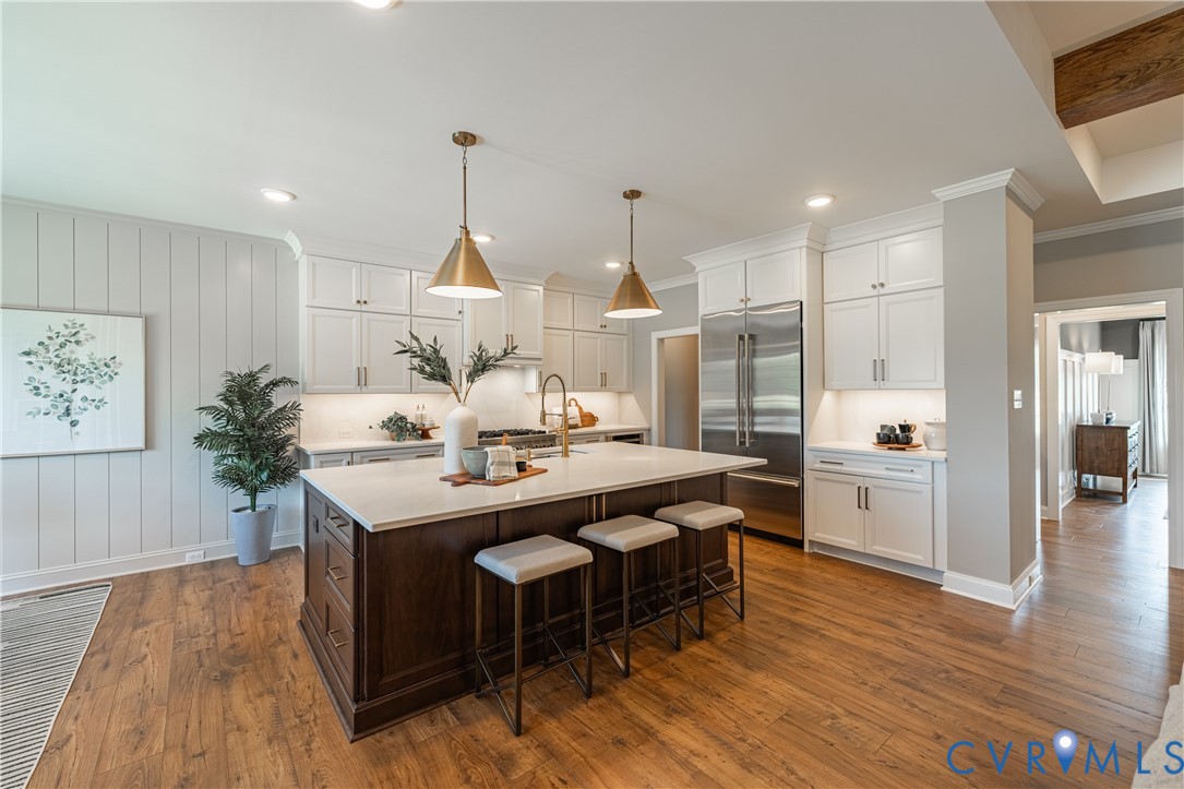 8264 Mt Eagle Road Ashland, VA 23005 - Photo 7 of 23 a kitchen with stainless steel appliances kitchen island wooden floor and large window