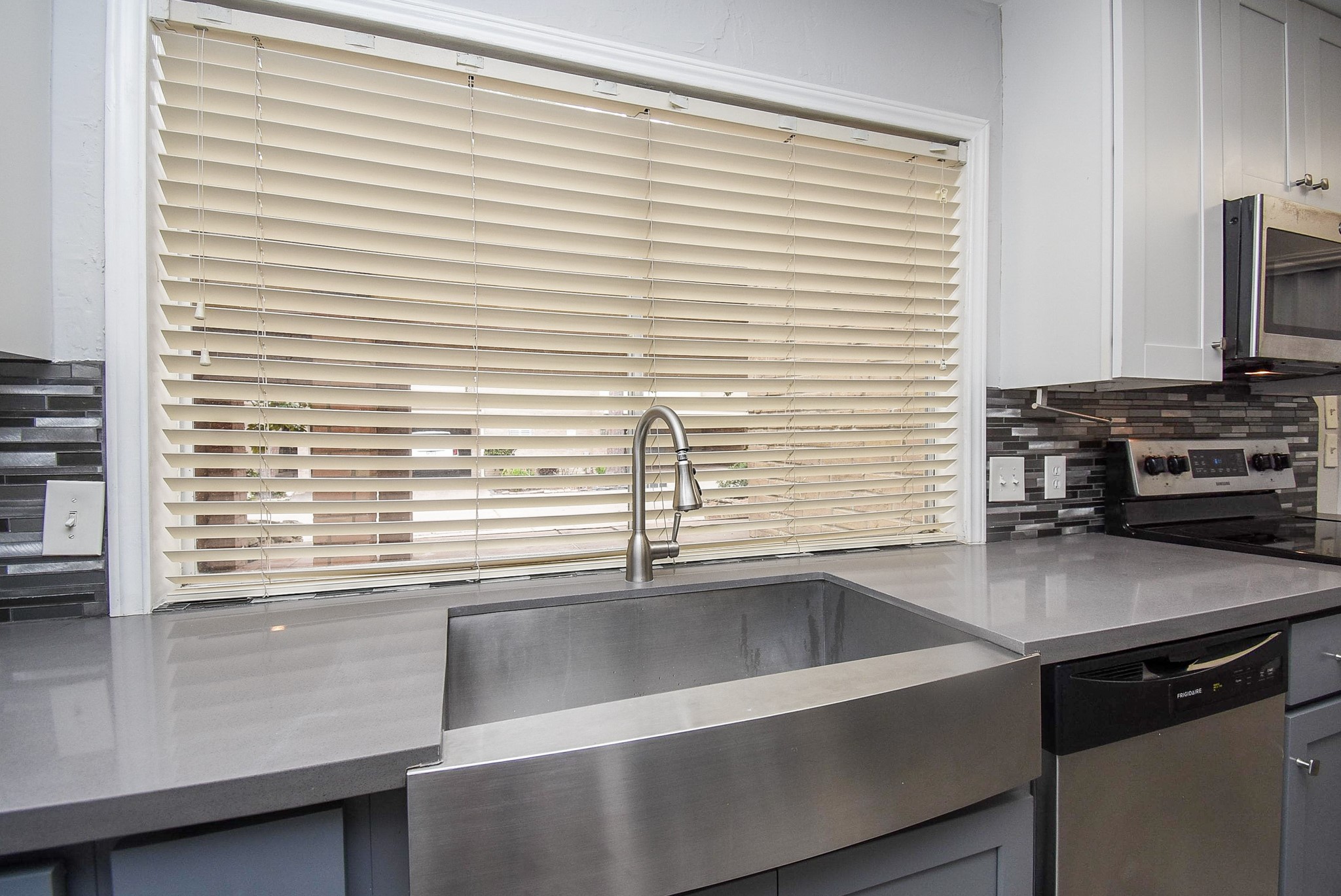 201 Vanderpool Lane, Unit 113 Houston, TX 77024 - Photo 17 of 45 a kitchen with a sink and a window