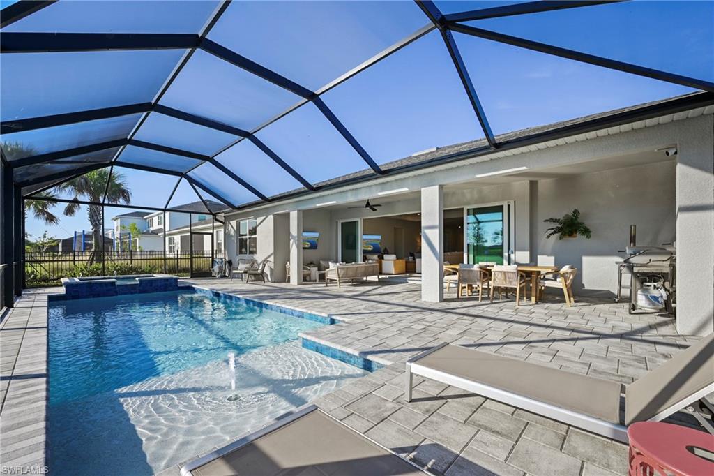 15764 Appalachian Drive Babcock Ranch, FL 33982 - Photo 16 of 46 a view of a patio with table and chairs under an umbrella