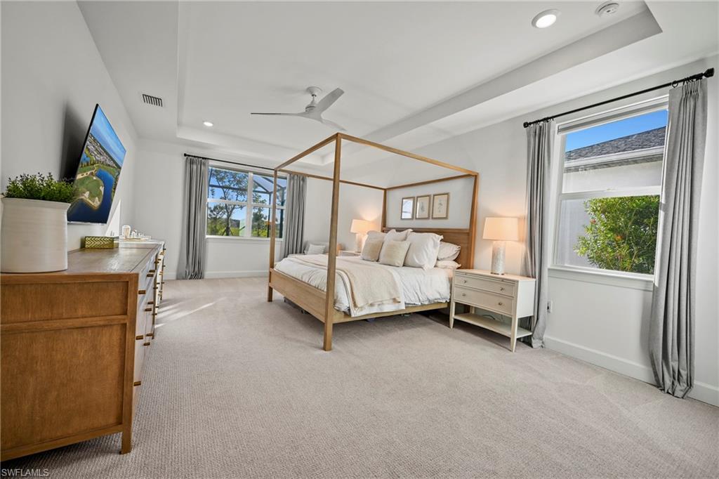 15764 Appalachian Drive Babcock Ranch, FL 33982 - Photo 22 of 46 a bedroom with a bed a couch and a flat tv screen