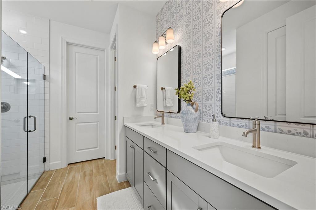 15764 Appalachian Drive Babcock Ranch, FL 33982 - Photo 25 of 46 a bathroom with a double vanity sink and a mirror