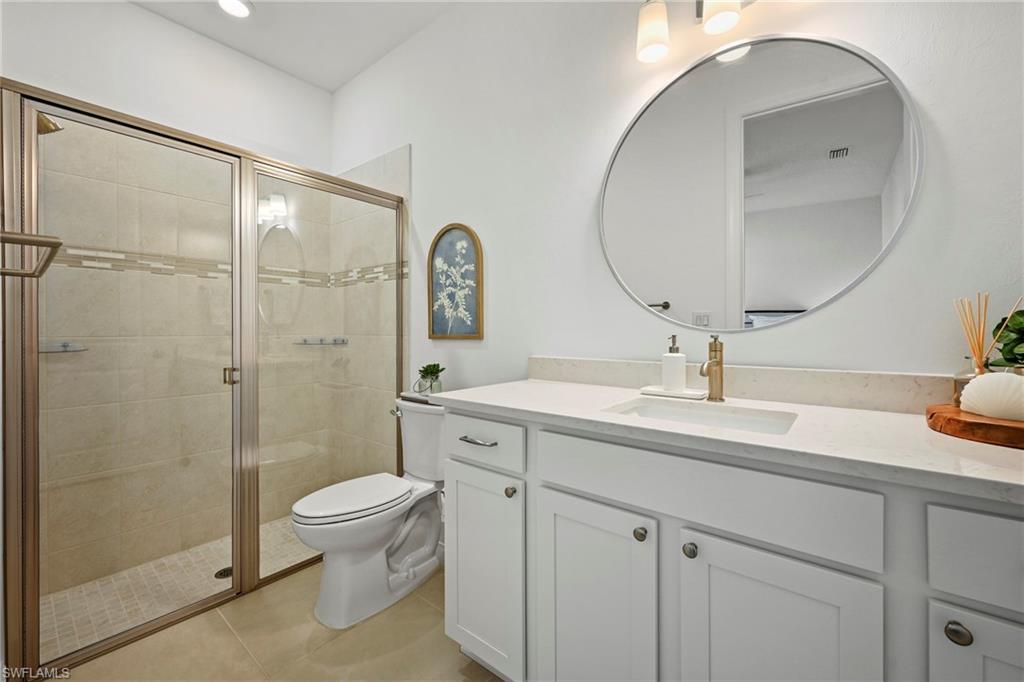 15764 Appalachian Drive Babcock Ranch, FL 33982 - Photo 32 of 46 a bathroom with a toilet a sink and a mirror