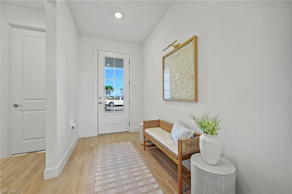 15764 Appalachian Drive Babcock Ranch, FL 33982 - Photo 37 of 46 a spacious bedroom with a bed and a table in it