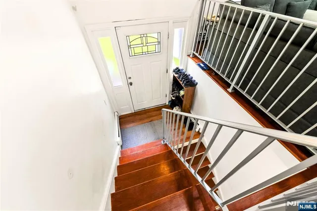 a kitchen with stainless steel appliances a table chairs sink and cabinets