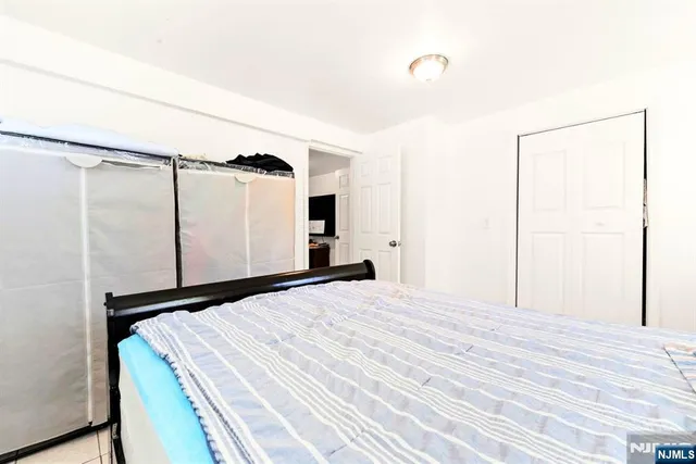 a bedroom with a bed chair and window