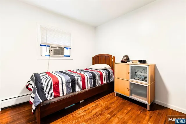 a bedroom with furniture and a fan
