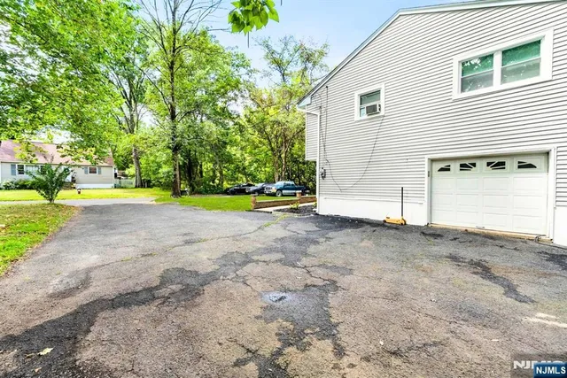 a view of a house with a yard and garage