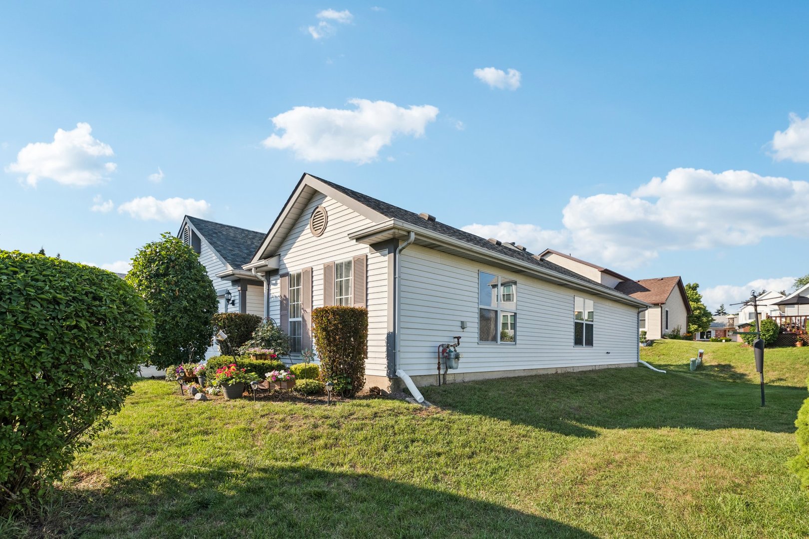 1192 Sumac Trail Hoffman Estates, IL 60192 - Photo 3 of 39 a view of a white house next to a yard with big trees