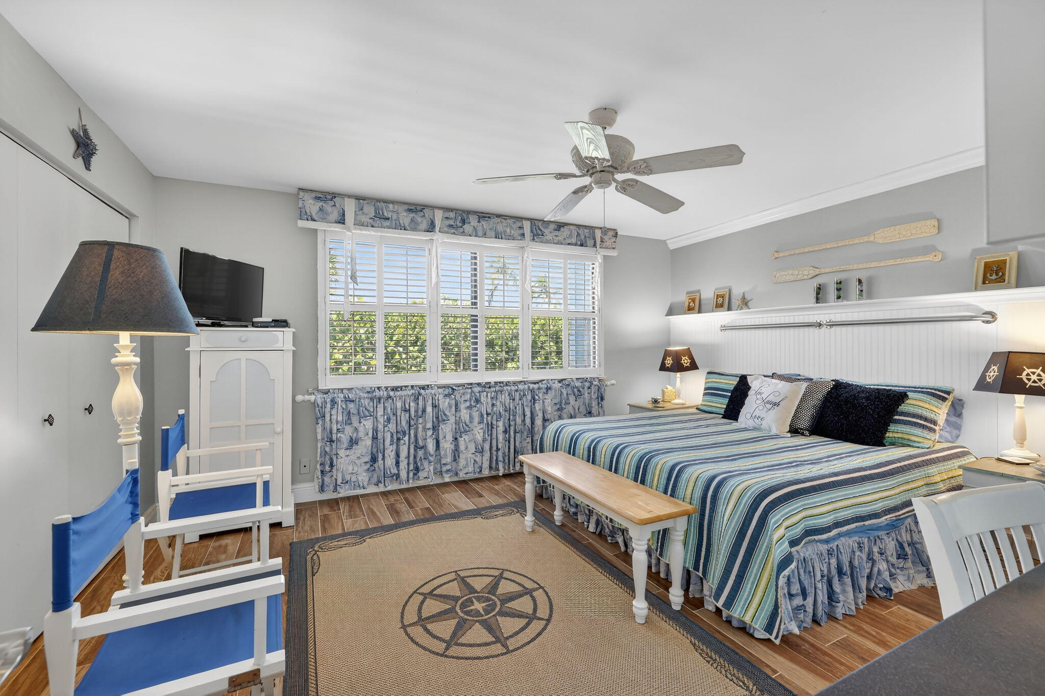 2355 Northeast Ocean Boulevard, Unit 17A Stuart, FL 34996 - Photo 14 of 30 a bedroom with a bed and a chandelier