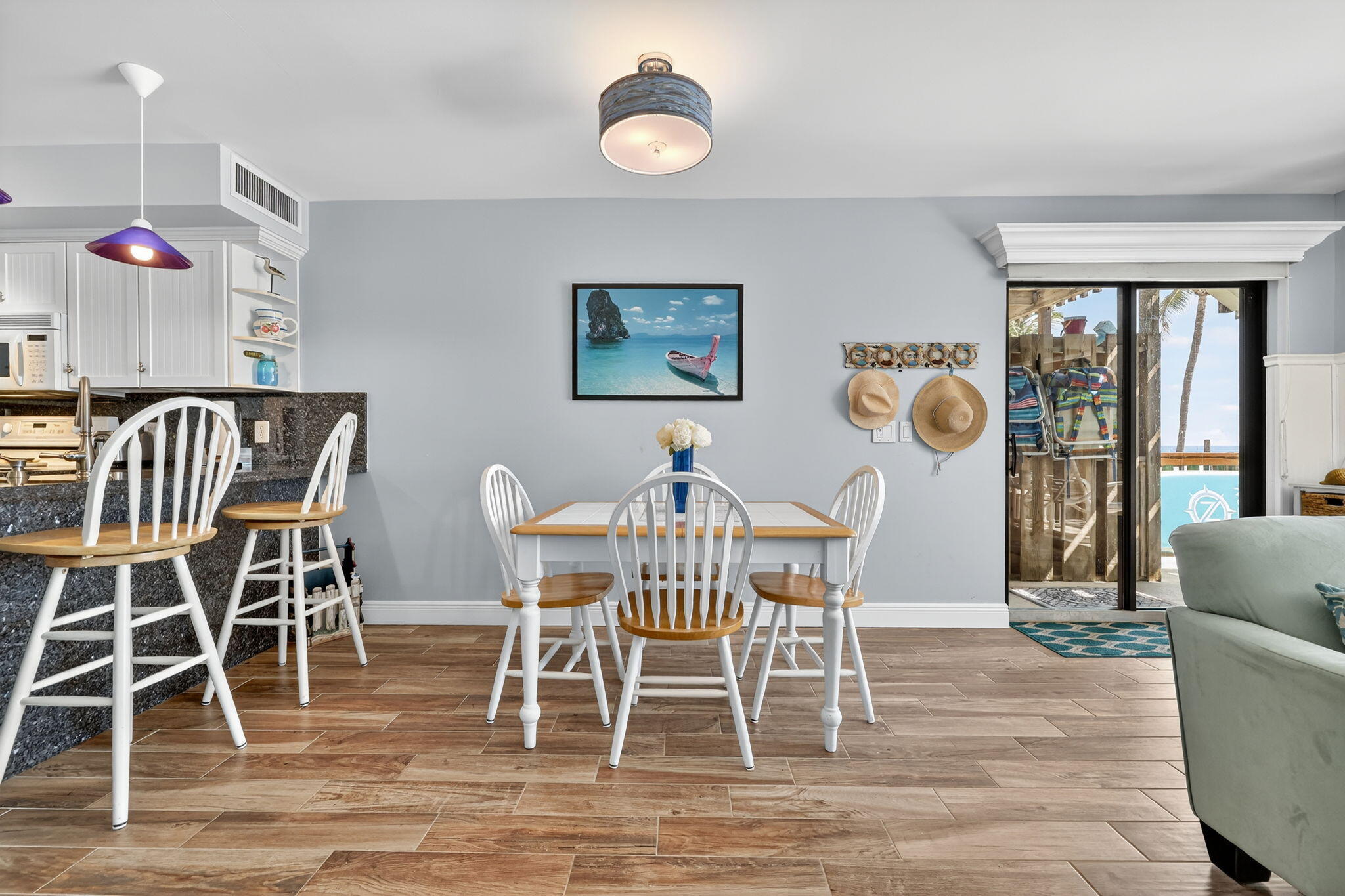 2355 Northeast Ocean Boulevard, Unit 17A Stuart, FL 34996 - Photo 2 of 30 a view of a dining room with furniture window and wooden floor