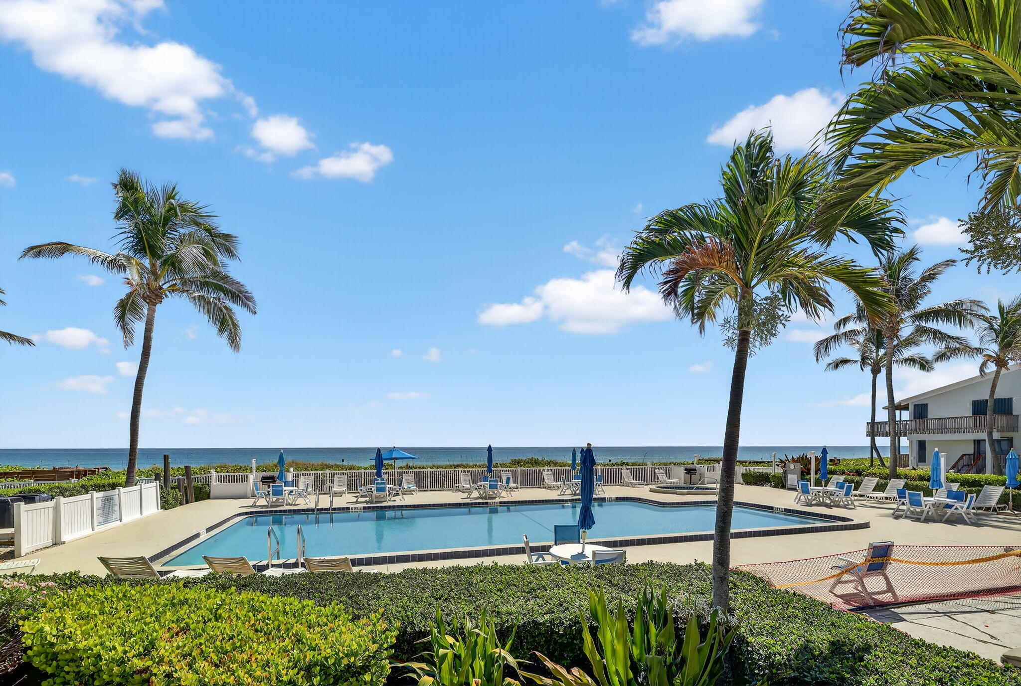 2355 Northeast Ocean Boulevard, Unit 17A Stuart, FL 34996 - Photo 22 of 30 a view of a swimming pool with a table and chairs