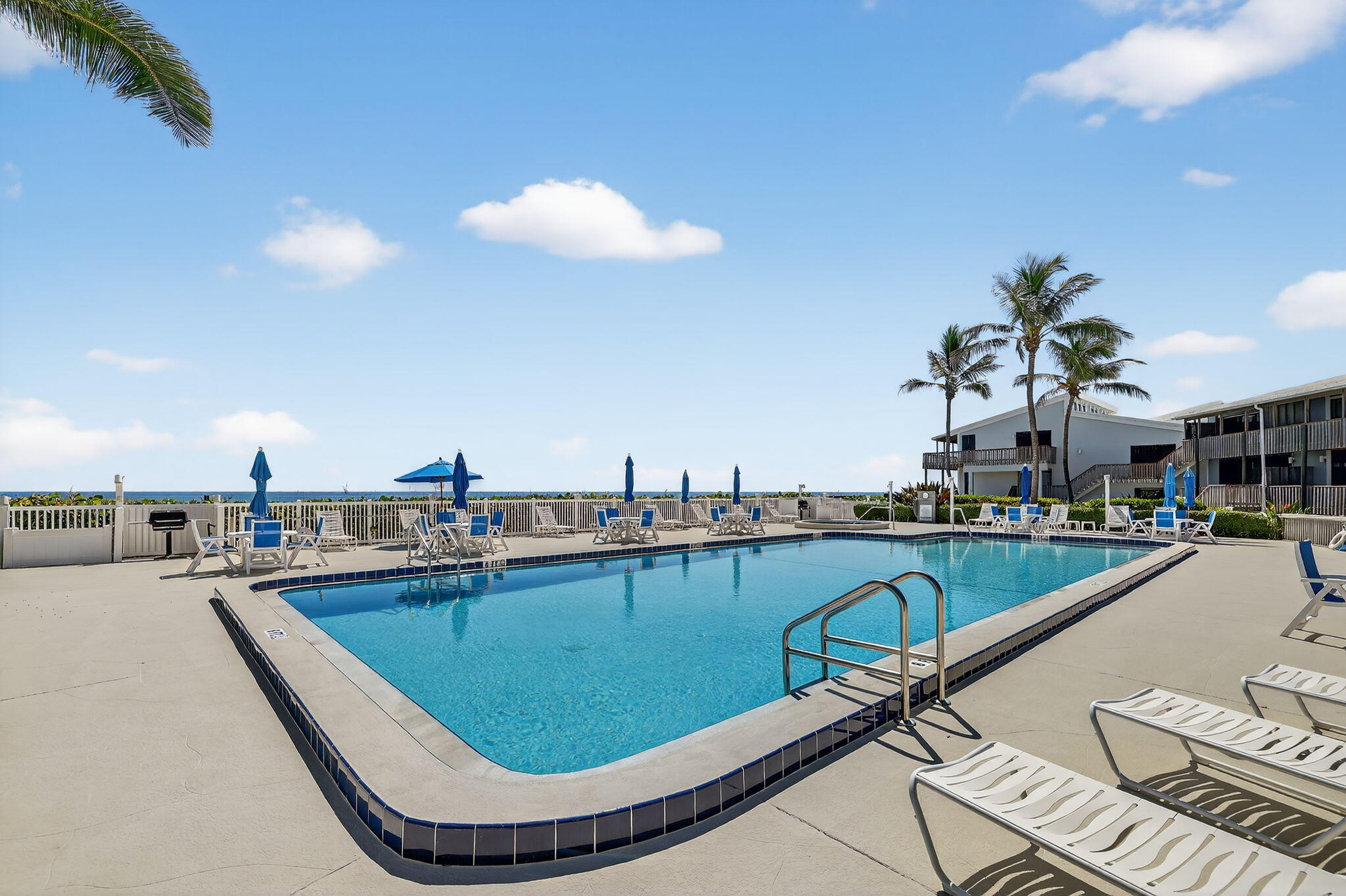 2355 Northeast Ocean Boulevard, Unit 17A Stuart, FL 34996 - Photo 23 of 30 a view of a swimming pool with outdoor seating space
