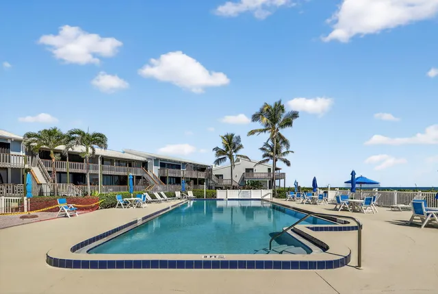a view of a swimming pool with outdoor seating