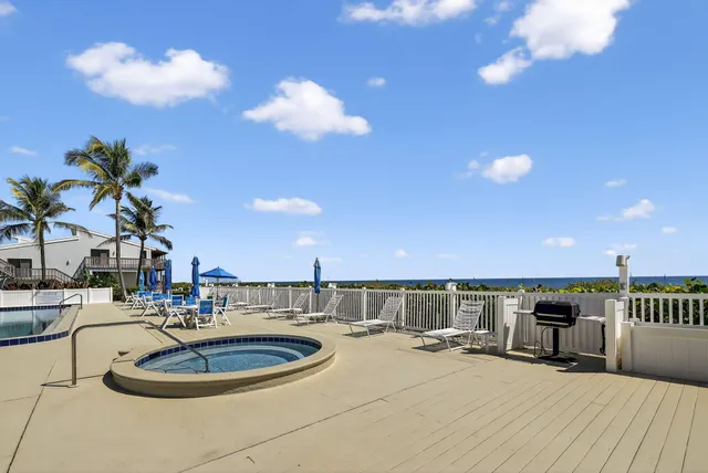 a room with kitchen island a sink and a chandelier