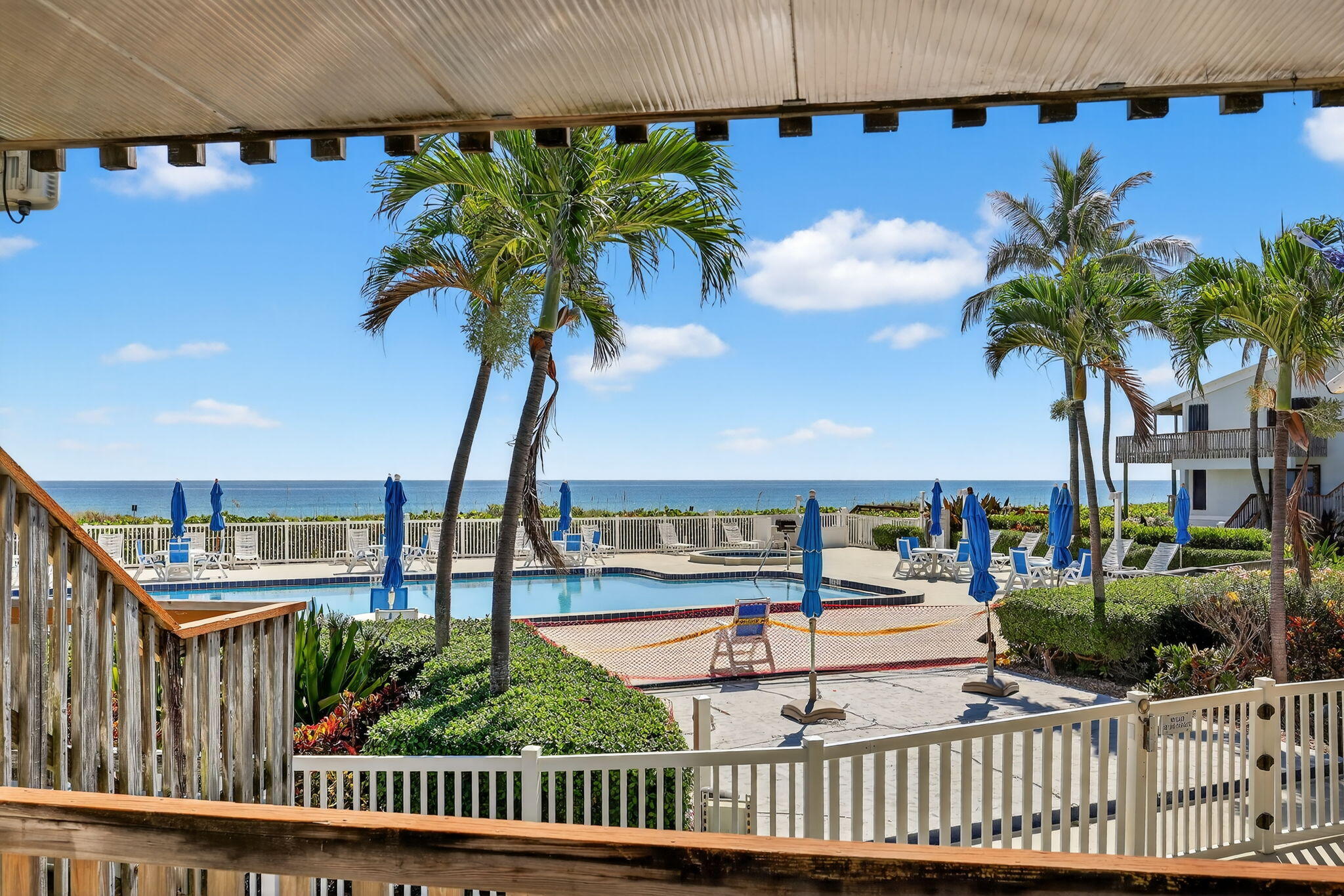 2355 Northeast Ocean Boulevard, Unit 17A Stuart, FL 34996 - Photo 4 of 30 a view of a swimming pool with a table and chairs